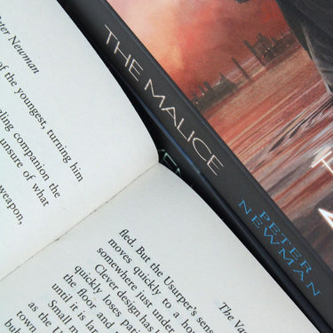 Photo of The Vagrant Trilogy Pages by Peter Newman on a White Background